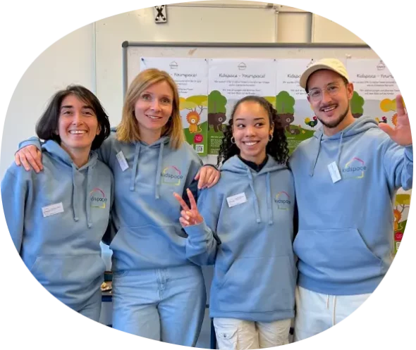 kidspace team Kidspace team in blue hoody standing in front of board with job adverts